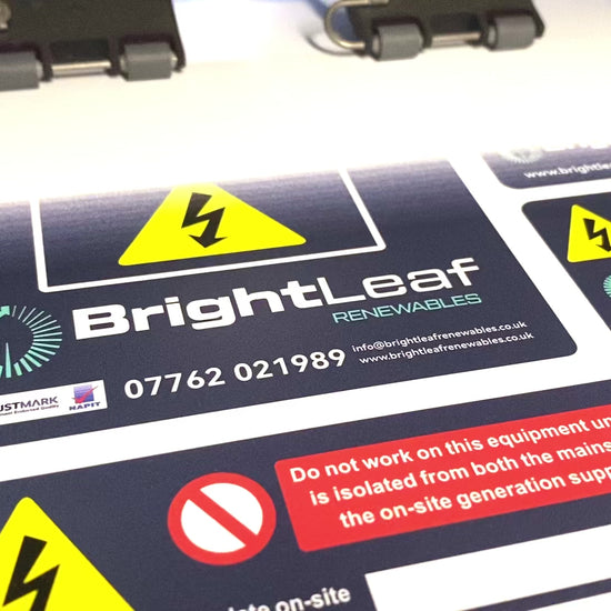 Custom printed Solar PV electrical labels showing safety and compliance stickers with business details for solar installations