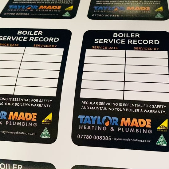 Boiler service record stickers showing maintenance history and inspection details for gas and heating systems