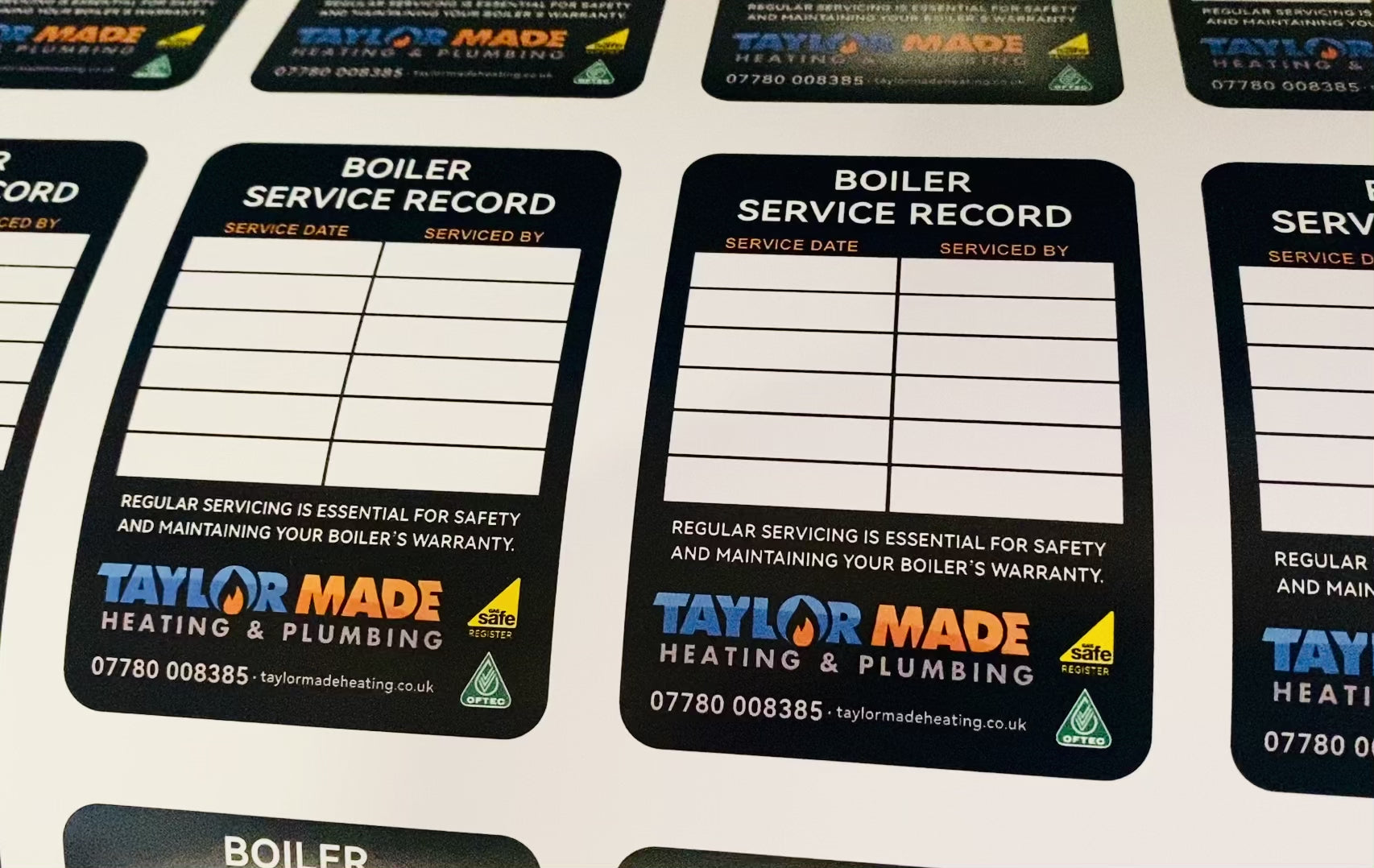 Boiler service record stickers showing maintenance history and inspection details for gas and heating systems
